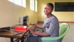 Photo showing young women working at sewing nachine